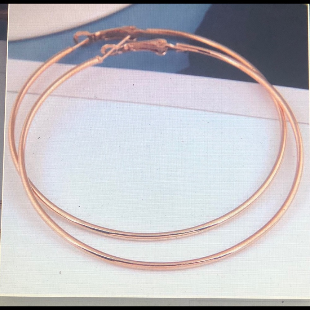 Large Thin gold tone Hoop earring.